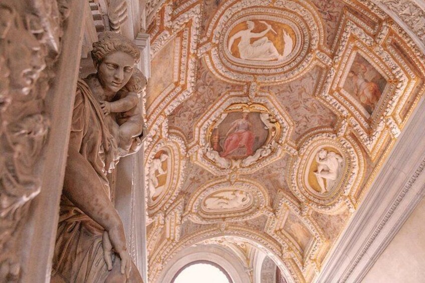 A detailed ceiling with ornate patterns and sculptures. 3