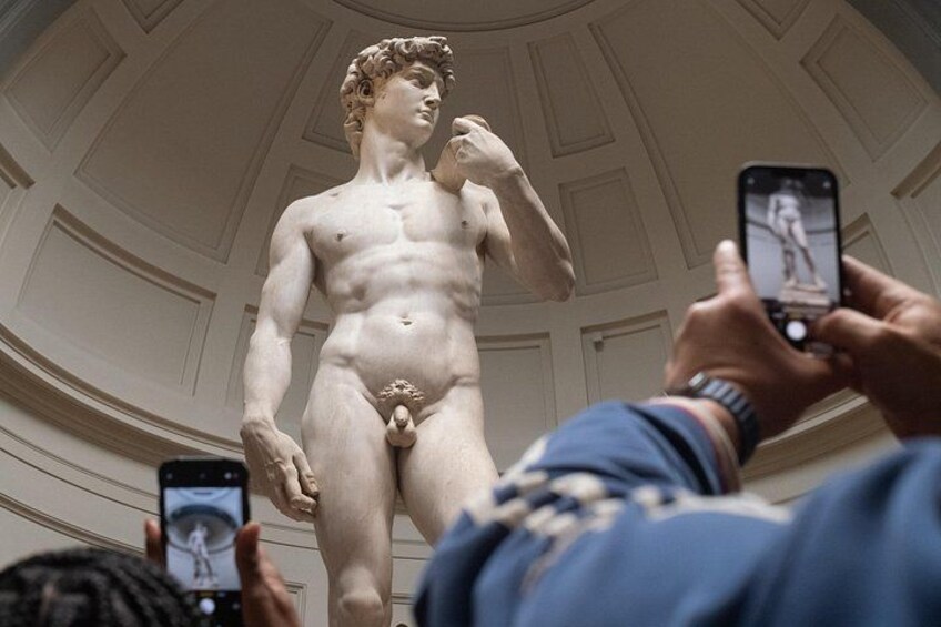 A marble statue in a room with a dome ceiling. 2