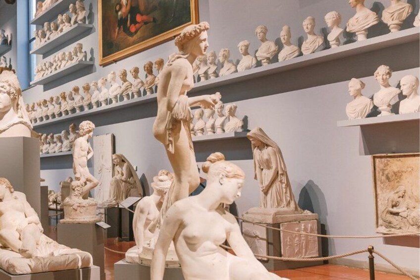 A museum with classical sculptures on display. 3