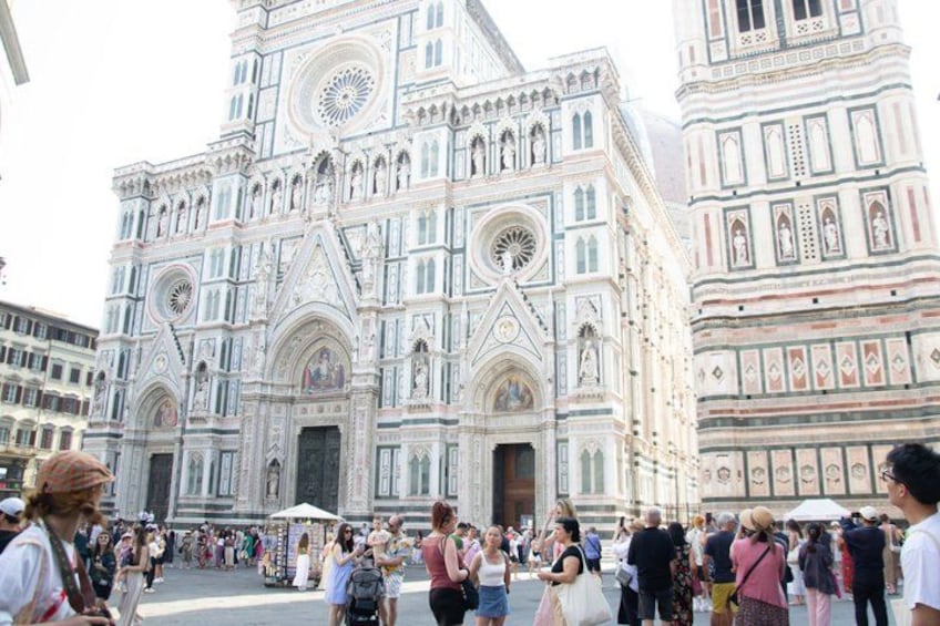 A large, ornate cathedral with intricate architectural details and a crowd of people in front. 2