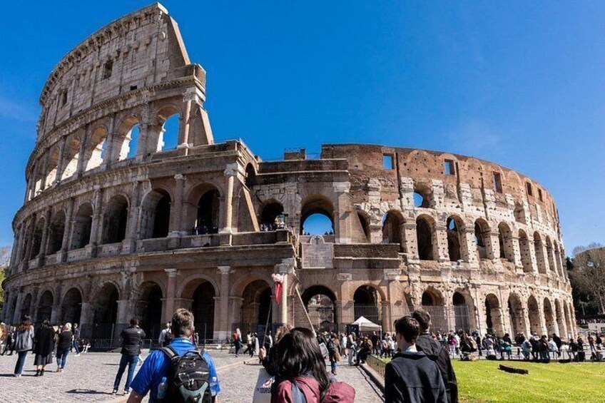 The Colosseum with visitors in front. 1
