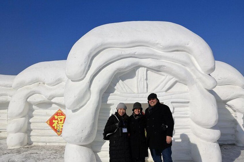 A large snow sculpture of a hand with a red sign in front. 3