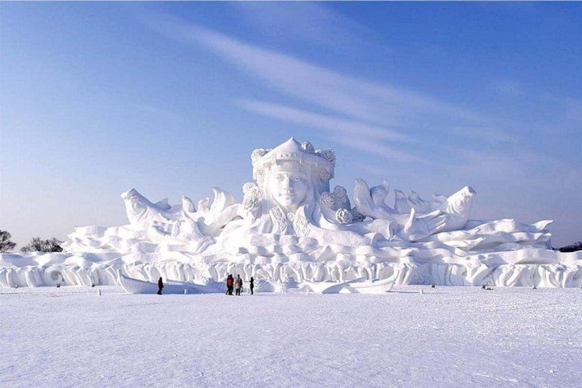 A large snow sculpture with intricate details and a central figure. 1