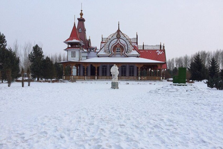 A snow-covered building with a red roof and ornate architecture. 4
