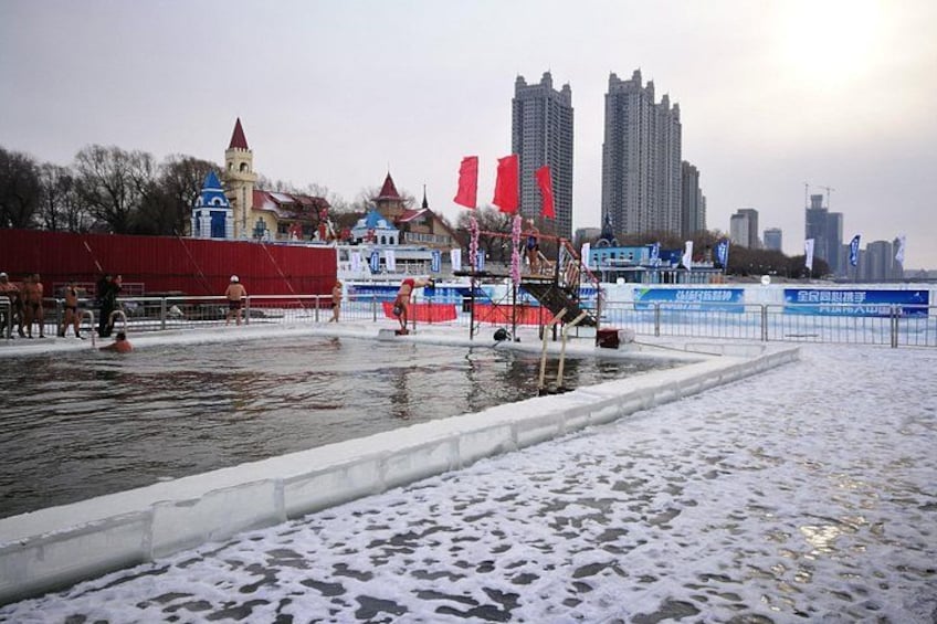 A frozen body of water with a castle-like structure in the background, surrounded by modern buildings. 4