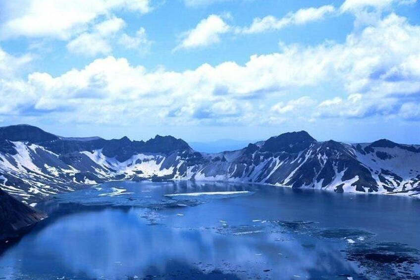 A mountainous landscape with a lake surrounded by snow-covered peaks. 5