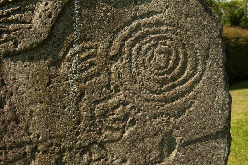 A stone with spiral carvings. 2