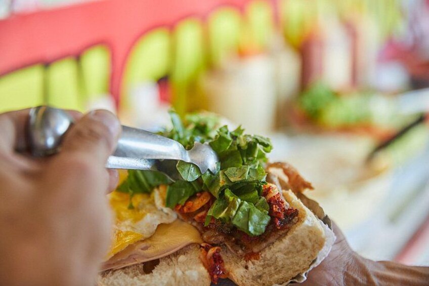 A person using tongs to handle food, likely in a restaurant setting. 5