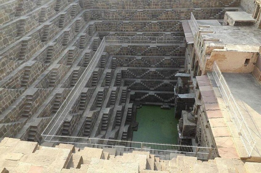 A large, ancient stone structure with a central courtyard and a surrounding wall. 4