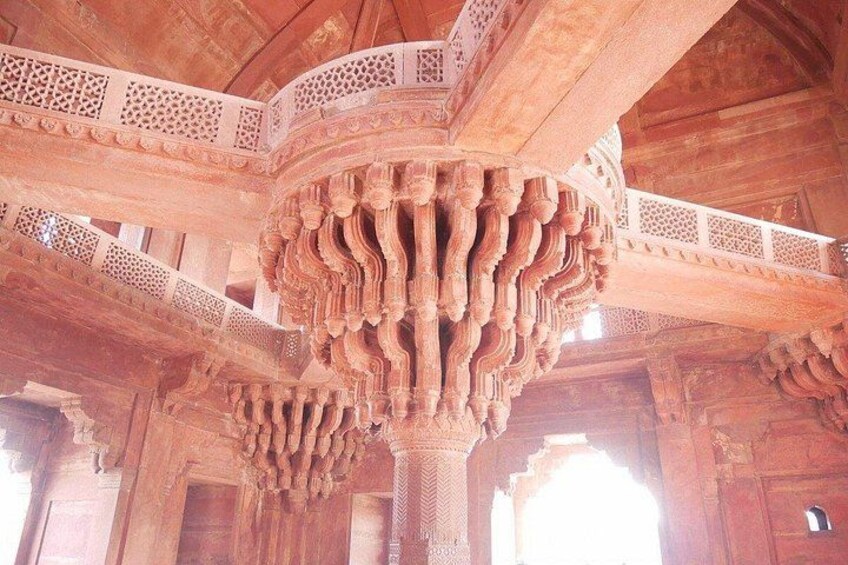Intricate wooden carvings and arches in a historical building. 3