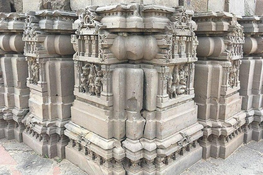 Intricately carved stone pillars with detailed sculptures. 2