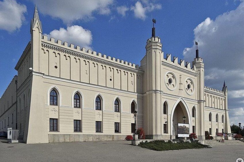 A large, historic building with a clock tower and arched windows. 3