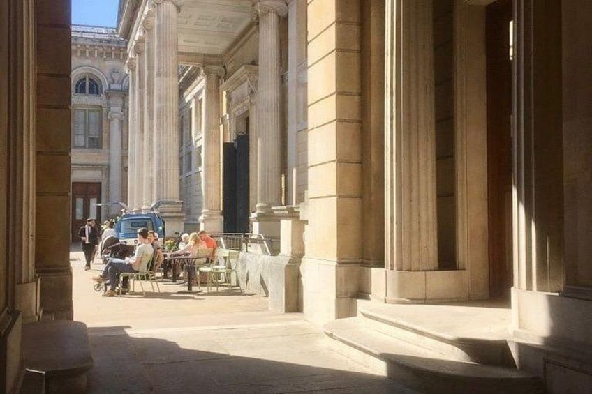 A street with classical architecture, including columns and steps. 3
