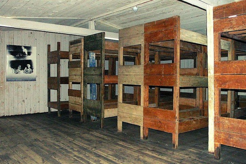Bunk beds in a room with wooden floors and walls. 2