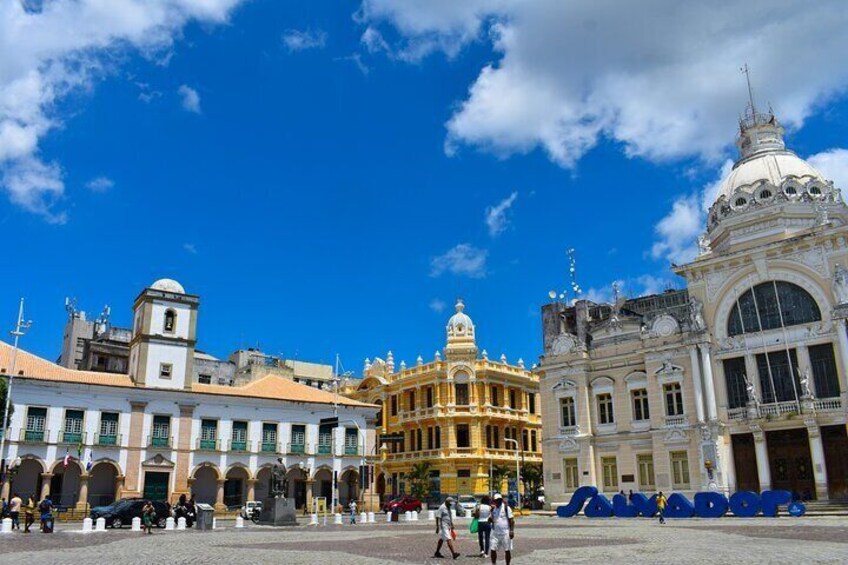 A historic plaza with ornate buildings, including a golden structure and a white building with a dome. 3