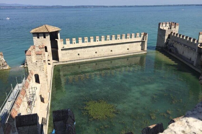 A historic fortification by the sea with clear waters and a tower. 2