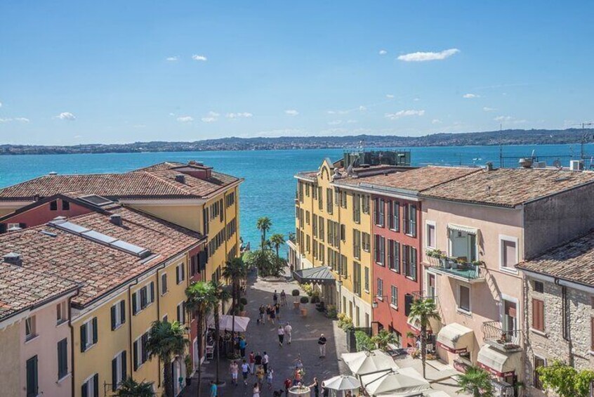 A coastal town with colorful buildings, a central square, and a view of the sea. 5