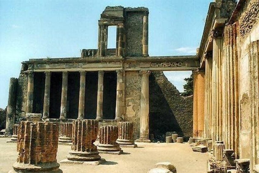 Ancient ruins with columns and a partially intact structure. 4