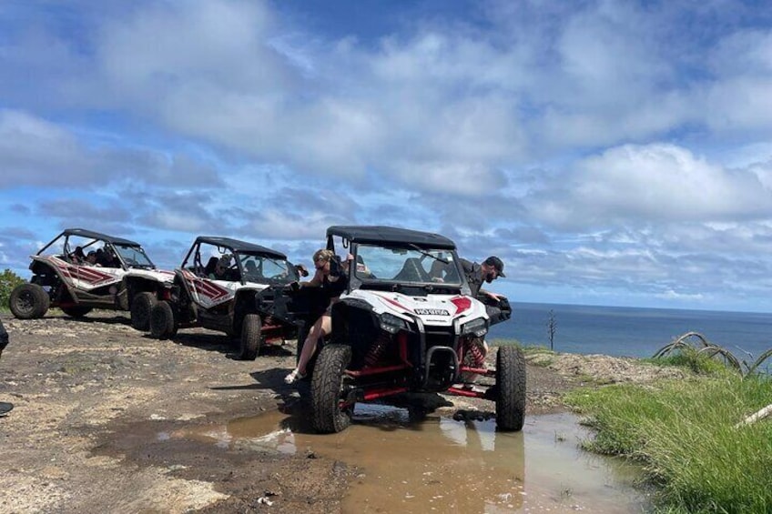 Off-road vehicles on a muddy terrain near a body of water. 3