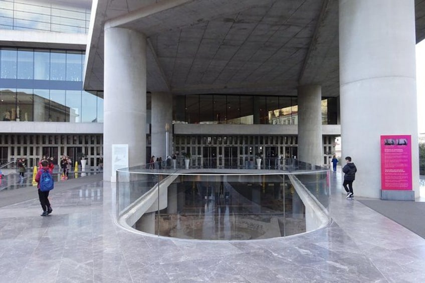 A modern building with a glass atrium and people walking around. 2