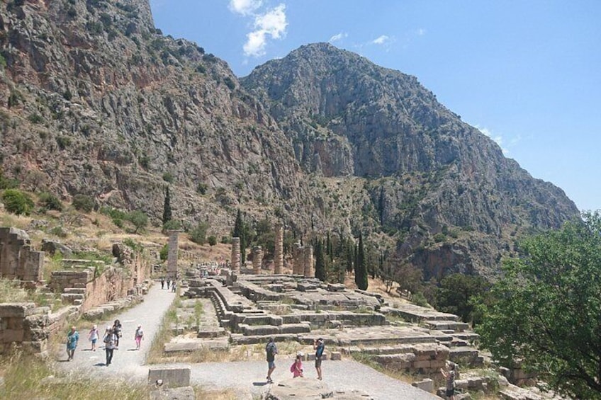 Ancient ruins with columns and a mountainous backdrop. 2