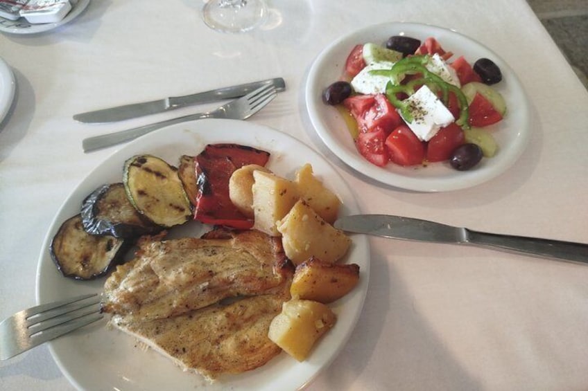 A plate of grilled vegetables and a bowl of salad with feta cheese. 3
