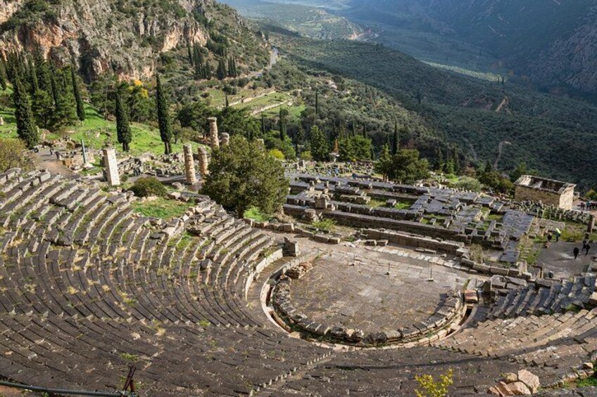 Een oud amfitheater met terrasvormige zitplaatsen en ruïnes in een bergachtig landschap. 4
