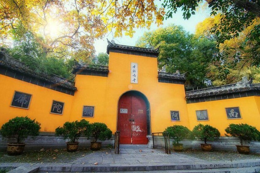 A traditional building with a red door, yellow walls, and Chinese characters. 2