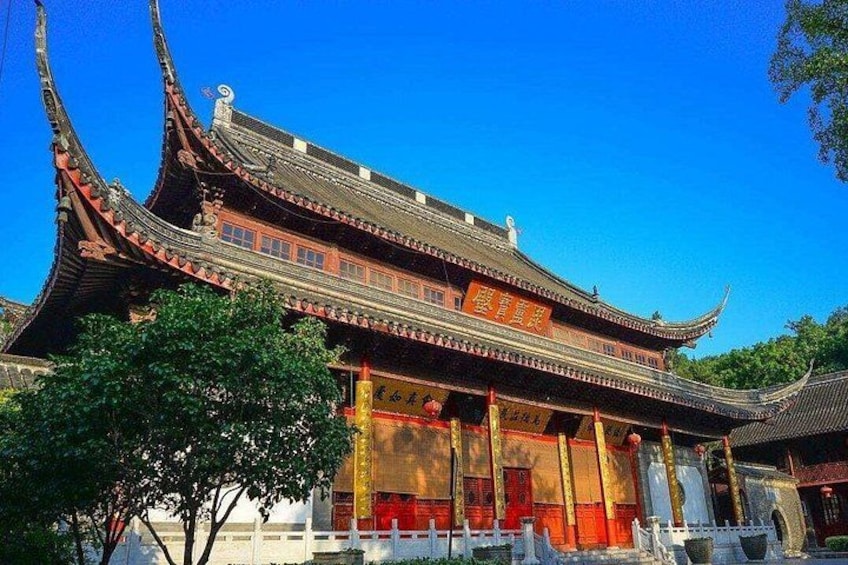 A traditional Chinese building with ornate architecture, including curved roofs and red accents. 5