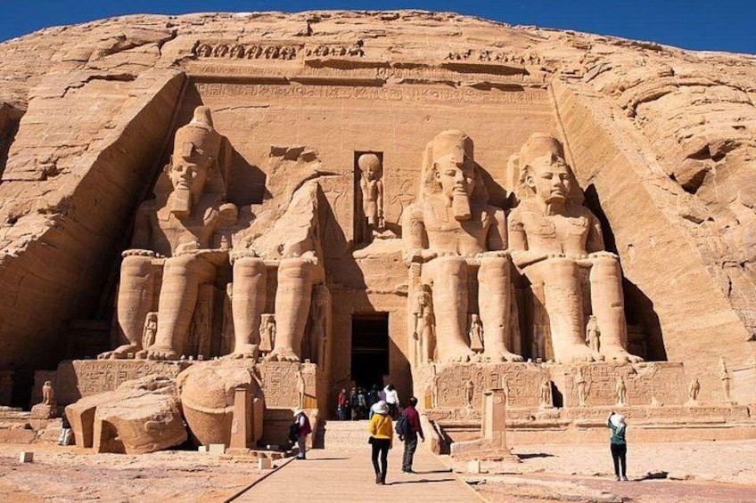 A large ancient Egyptian temple with colossal statues of pharaohs and hieroglyphics. 5