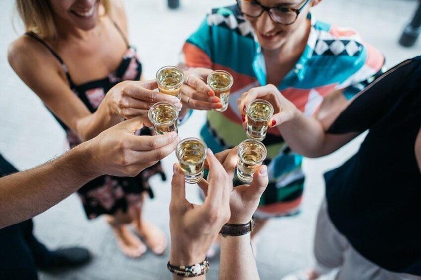 Een groep mensen met shotglazen, vermoedelijk aan het proosten. 1