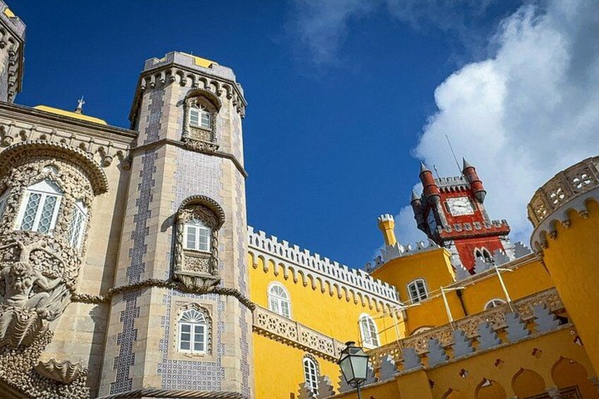 A yellow building with a tower and a clock tower. 5