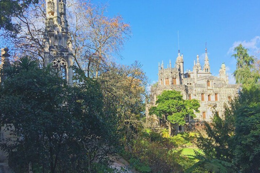 A historic building with intricate architecture, surrounded by lush greenery. 3