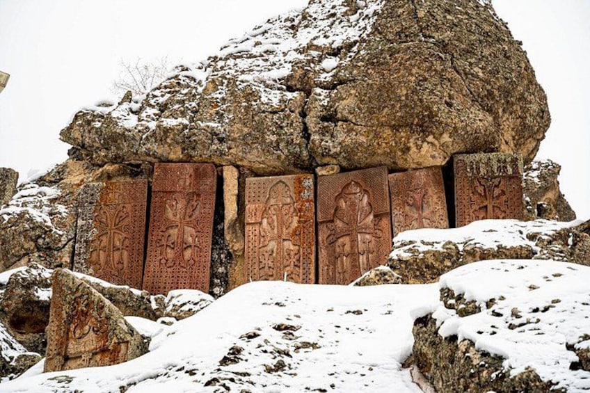 A rock formation with carved panels and snow. 2