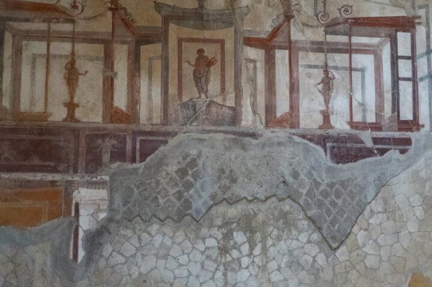 A fresco with figures and architectural elements, including a staircase and columns. 2