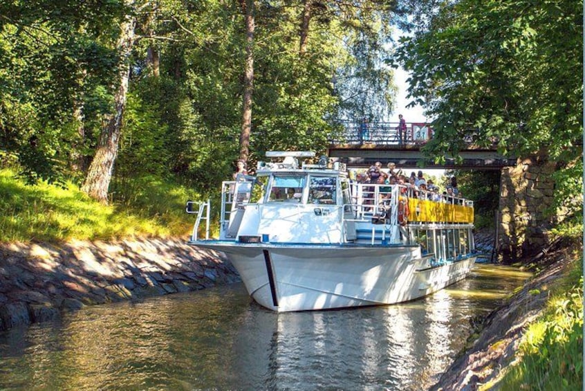 A boat on a river with a bridge in the background. 1