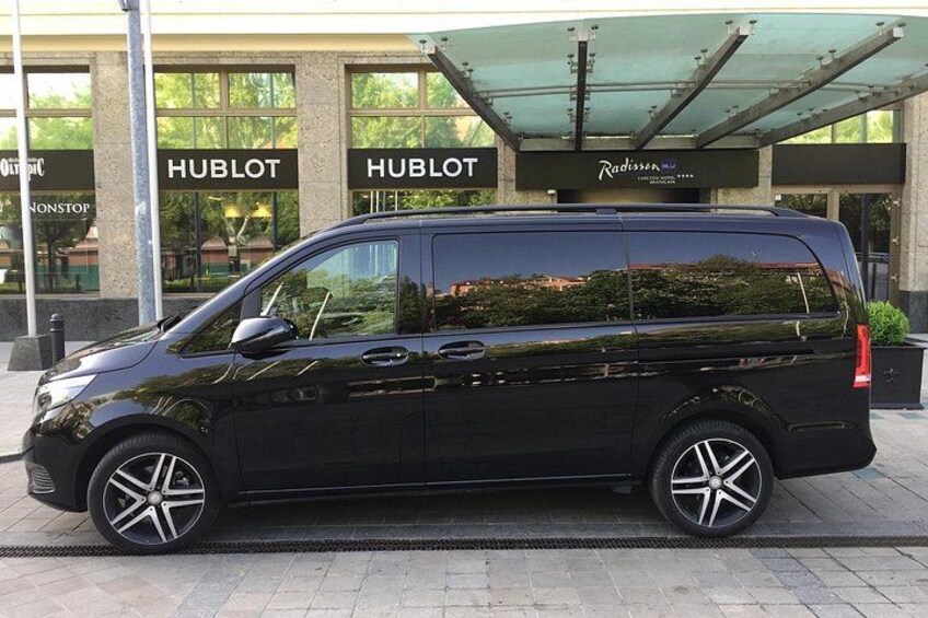 Una camioneta negra estacionada frente a un edificio con letrero 'HUBLOT'. 3