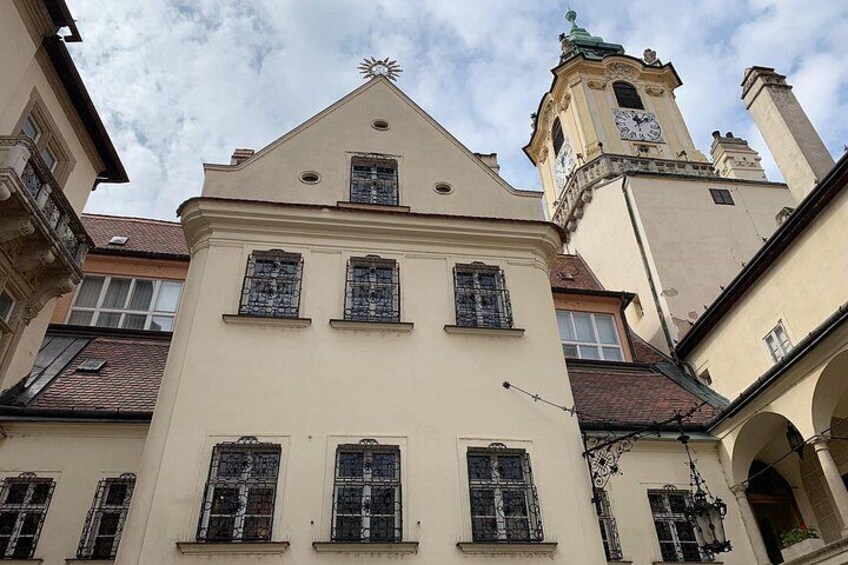 A building with a clock tower, ornate windows, and a star on the roof. 4