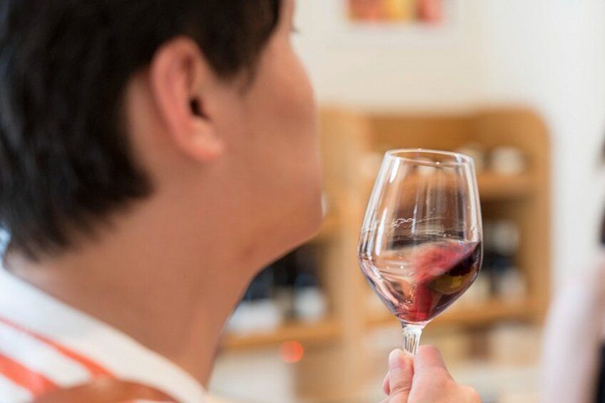 A person holding a wine glass. 3