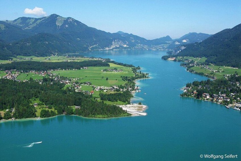 A river winding through a valley with mountains in the background. 1