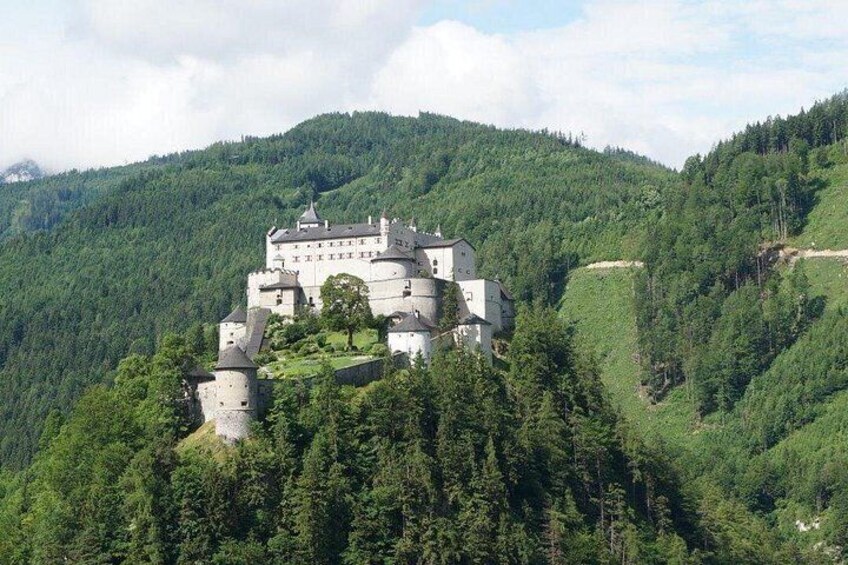 A castle on a hill surrounded by forest. 2