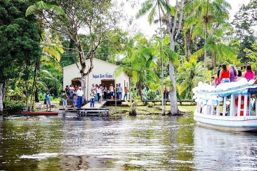 A boat docked at a pier with people boarding and disembarking. 3