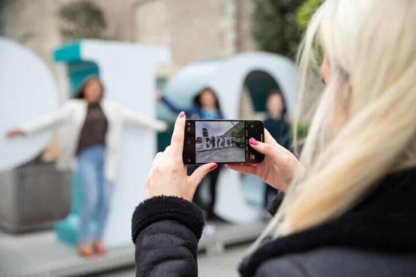 A person taking a photo with a smartphone. 3