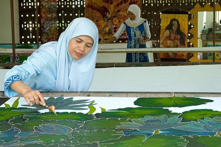 A person painting a large, detailed mural of water lilies. 5
