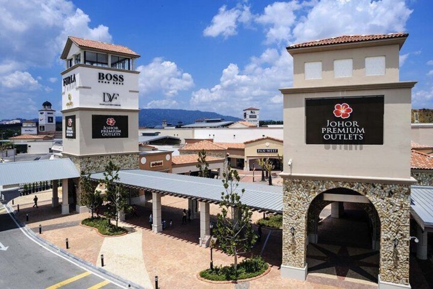 A commercial area with multiple buildings, including a tower labeled 'BOSS' and a sign for 'JOHOR PREMIUM OUTLETS'. 4