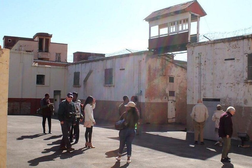 A group of people standing in an outdoor area with buildings in the background. 5