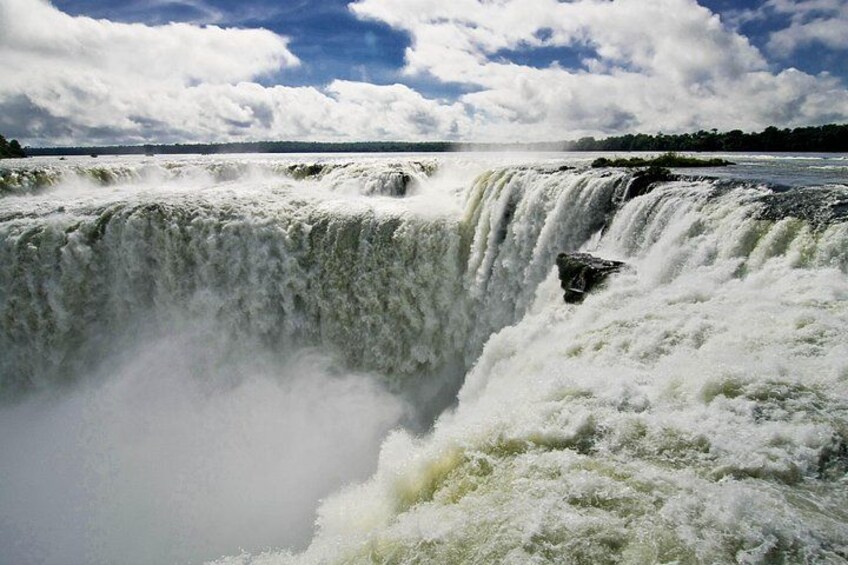 A powerful waterfall with mist and turbulent water. 4