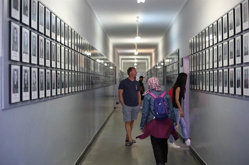 A hallway with framed pictures on the walls. 1