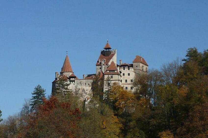 A castle with multiple towers and a steep hill. 1