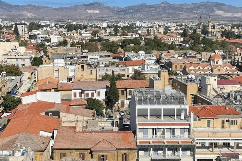A densely packed urban area with a mix of traditional and modern architecture, including a prominent minaret. 3